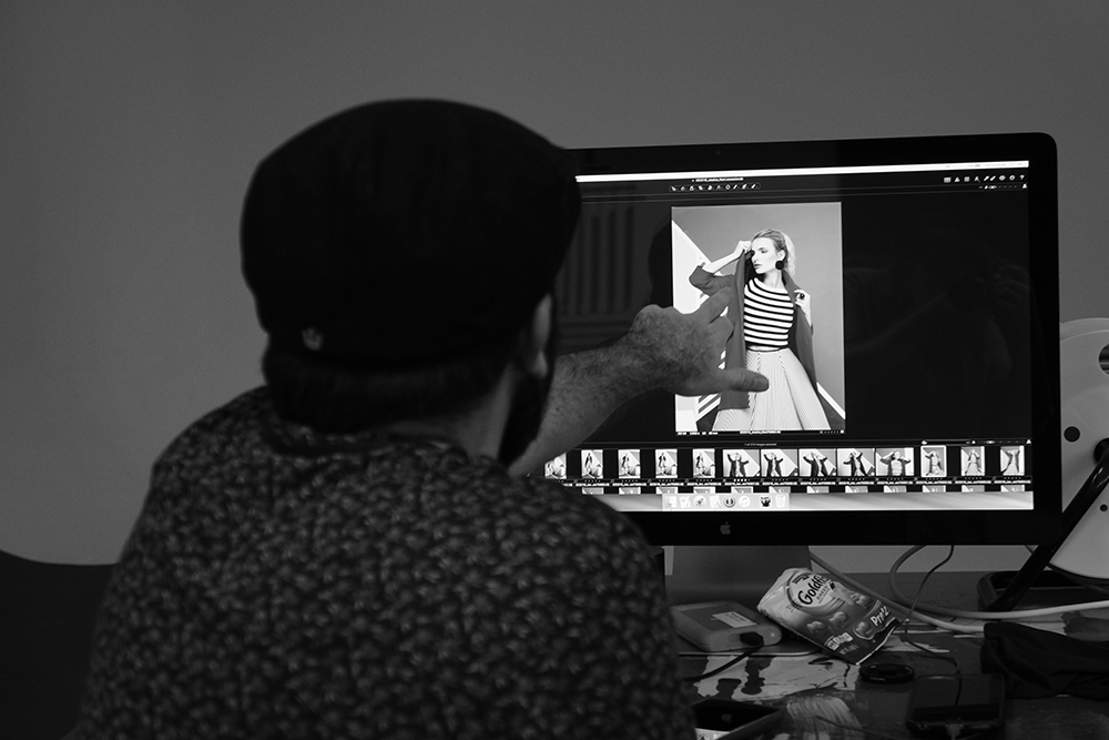 Photographer looking through images in Miami studio
